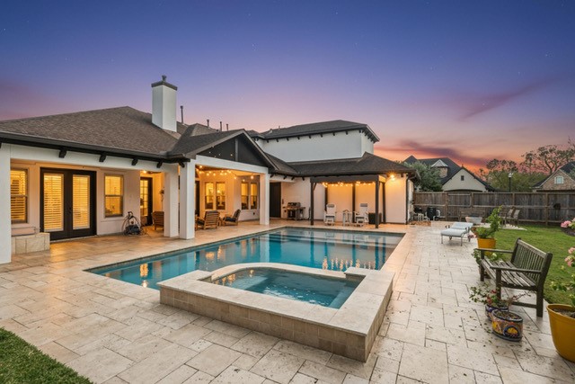 1702 Hunters Trail Friendswood, TX 77546 - Photo 2 of 42 a view of a house with swimming pool and sitting area
