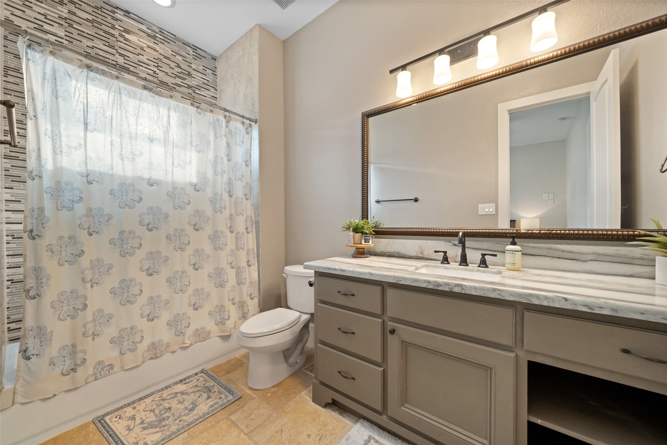 1702 Hunters Trail Friendswood, TX 77546 - Photo 30 of 42 a bathroom with a granite countertop sink a toilet and a mirror