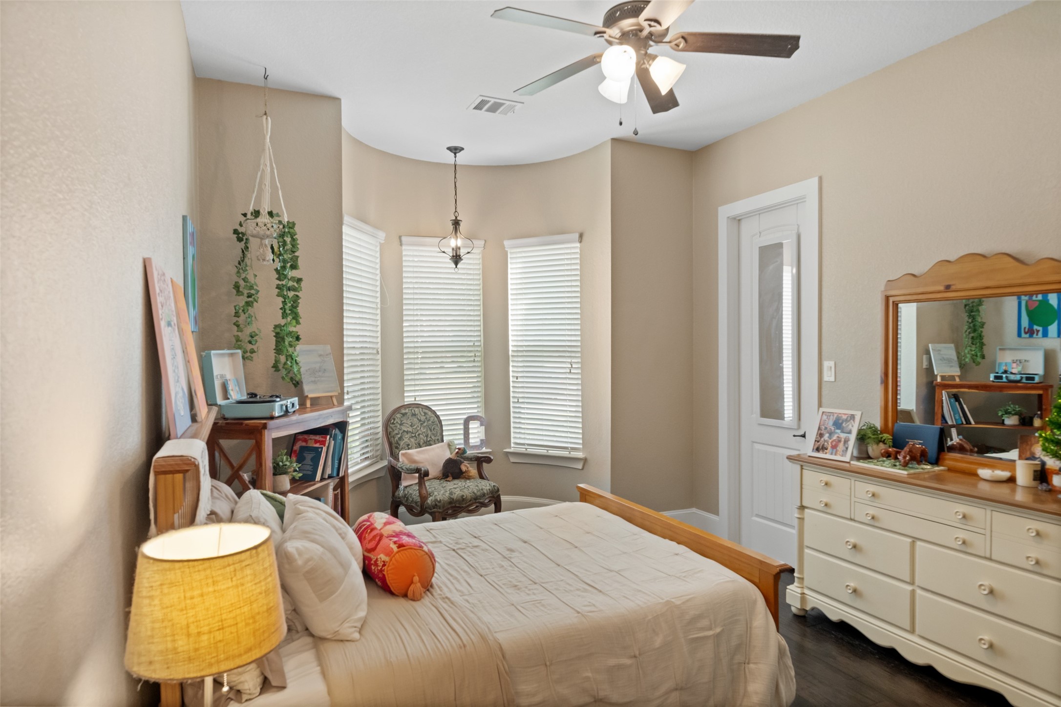 1702 Hunters Trail Friendswood, TX 77546 - Photo 31 of 42 a bedroom with a bed and a chandelier