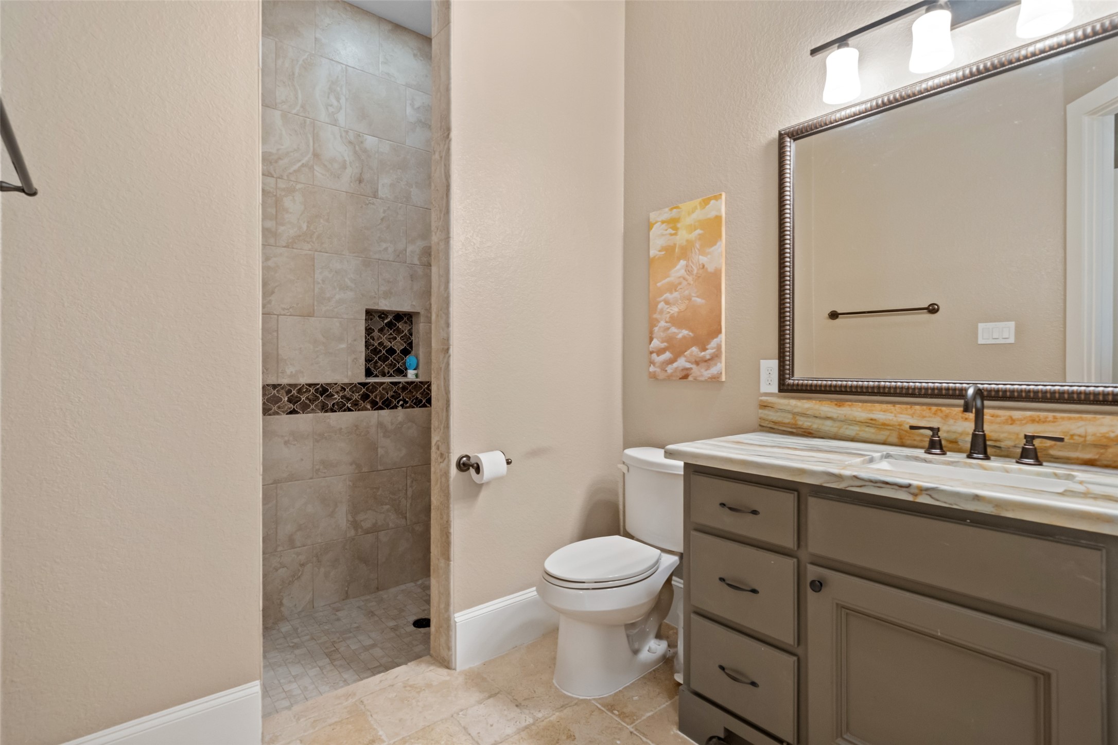1702 Hunters Trail Friendswood, TX 77546 - Photo 32 of 42 a bathroom with a granite countertop toilet sink and mirror