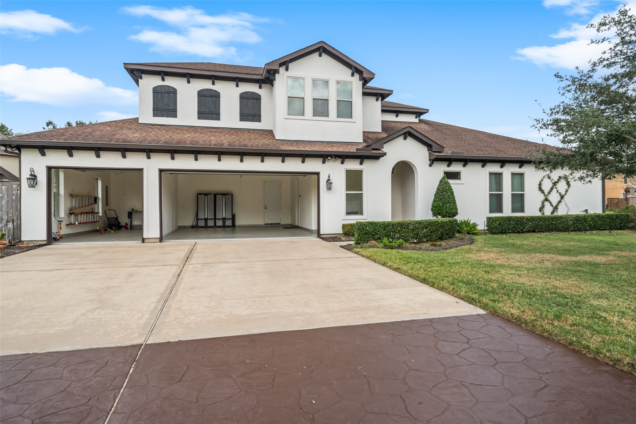 1702 Hunters Trail Friendswood, TX 77546 - Photo 8 of 42 a front view of a house with a yard and garage