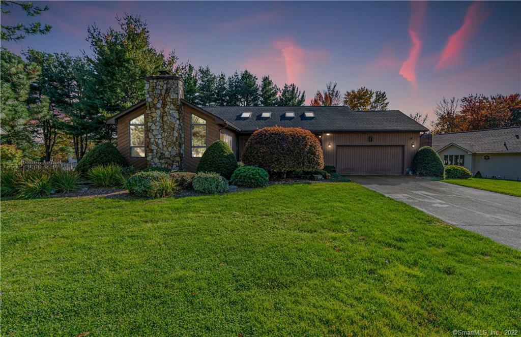 a view of a house with a yard and a garage