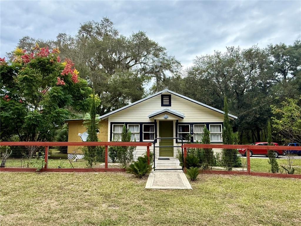 a front view of a house with a yard table and chairs