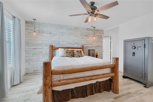 a bedroom with a bed and a chandelier