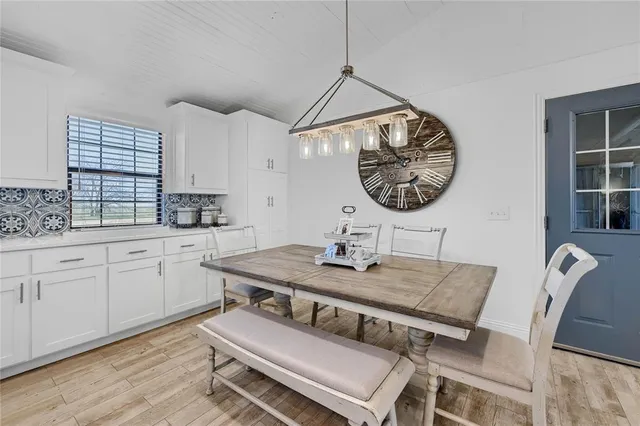 a kitchen with a table chairs and a stove