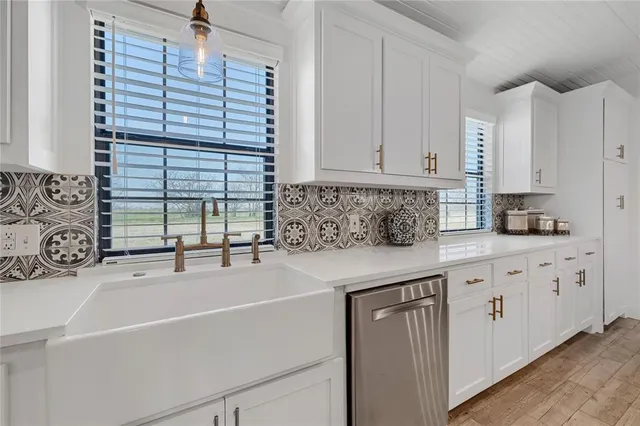 a kitchen with a sink and cabinets