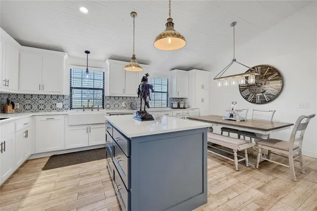 a kitchen with a sink cabinets and window