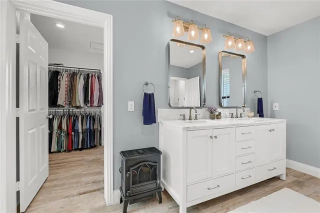 a bathroom with a double vanity sink and a mirror