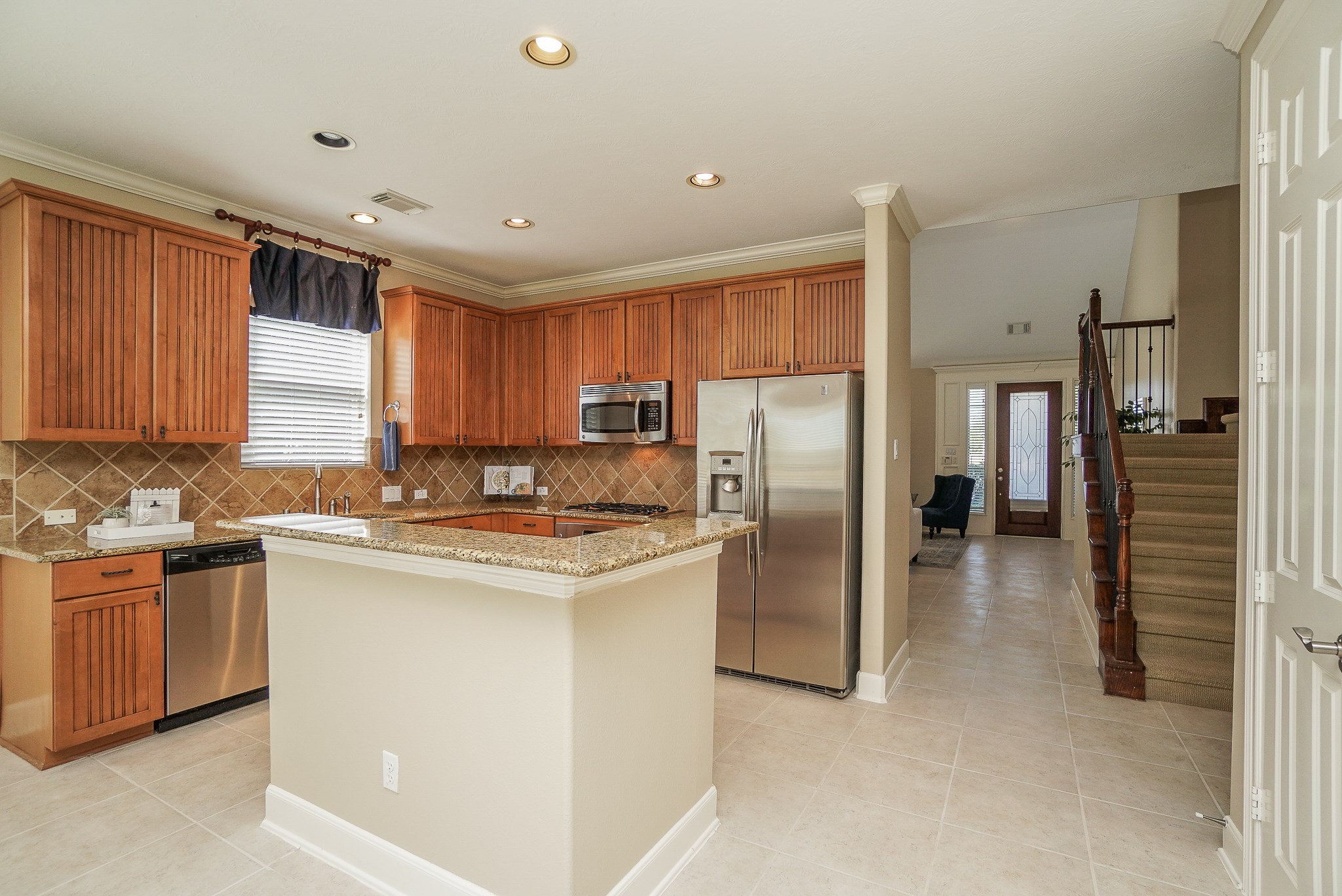 2335 Ralston Branch Way Sugar Land, TX 77479 - Photo 19 of 47 a kitchen with stainless steel appliances granite countertop a refrigerator a sink a stove and a refrigerator