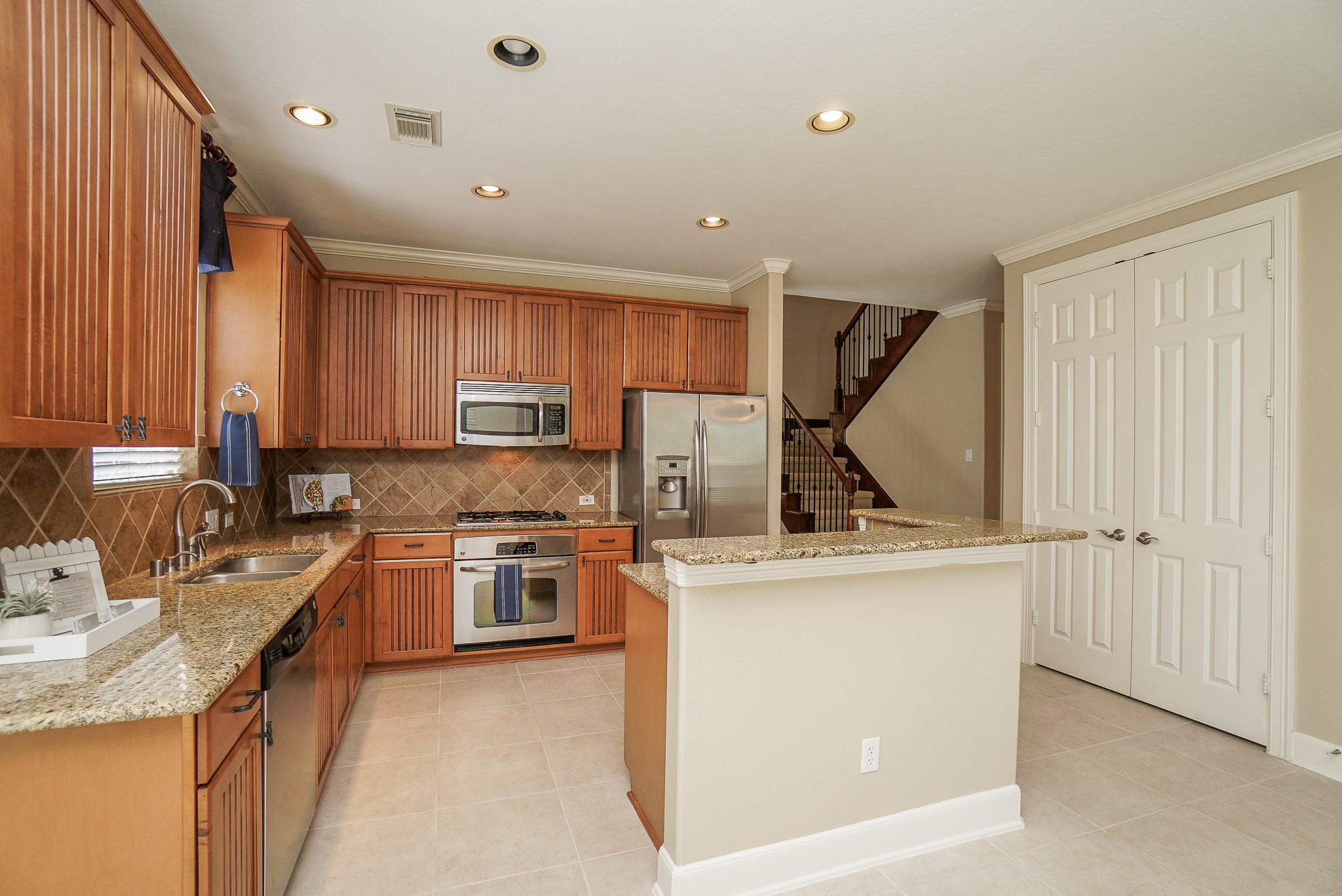 2335 Ralston Branch Way Sugar Land, TX 77479 - Photo 21 of 47 a kitchen with a sink stove and refrigerator