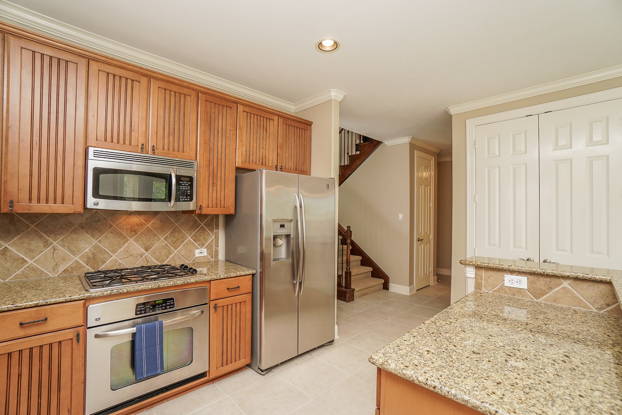 2335 Ralston Branch Way Sugar Land, TX 77479 - Photo 22 of 47 a kitchen with stainless steel appliances granite countertop a stove a sink and a microwave