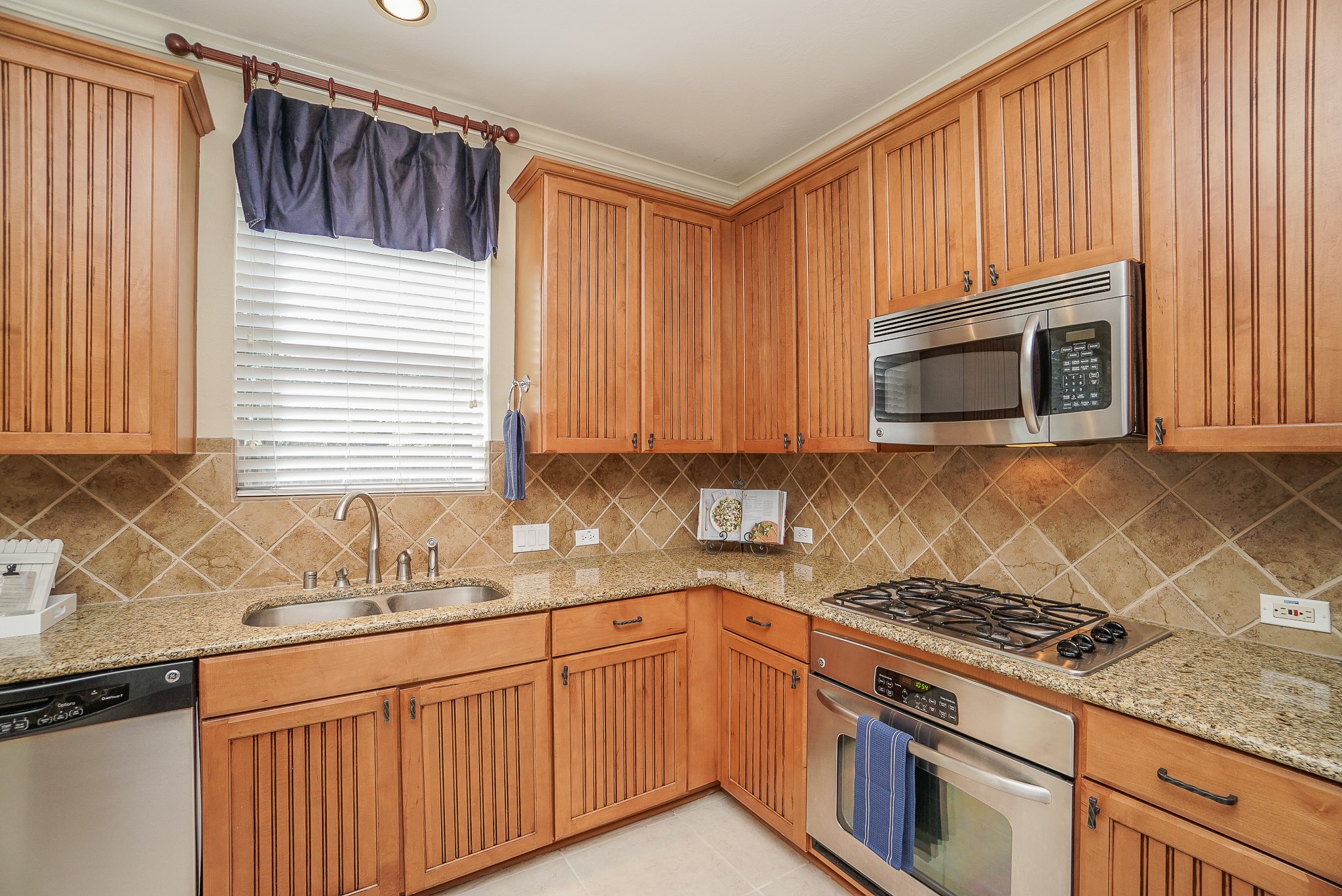 2335 Ralston Branch Way Sugar Land, TX 77479 - Photo 23 of 47 a kitchen with granite countertop cabinets stainless steel appliances and a sink