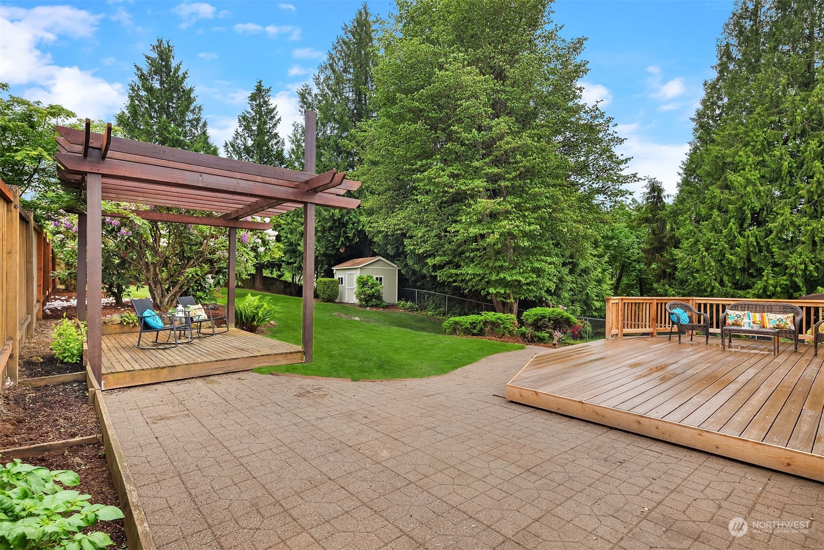 1909 Northeast 24th Street Renton, WA 98056 - Photo 30 of 34 a view of a patio with a table chairs and a backyard