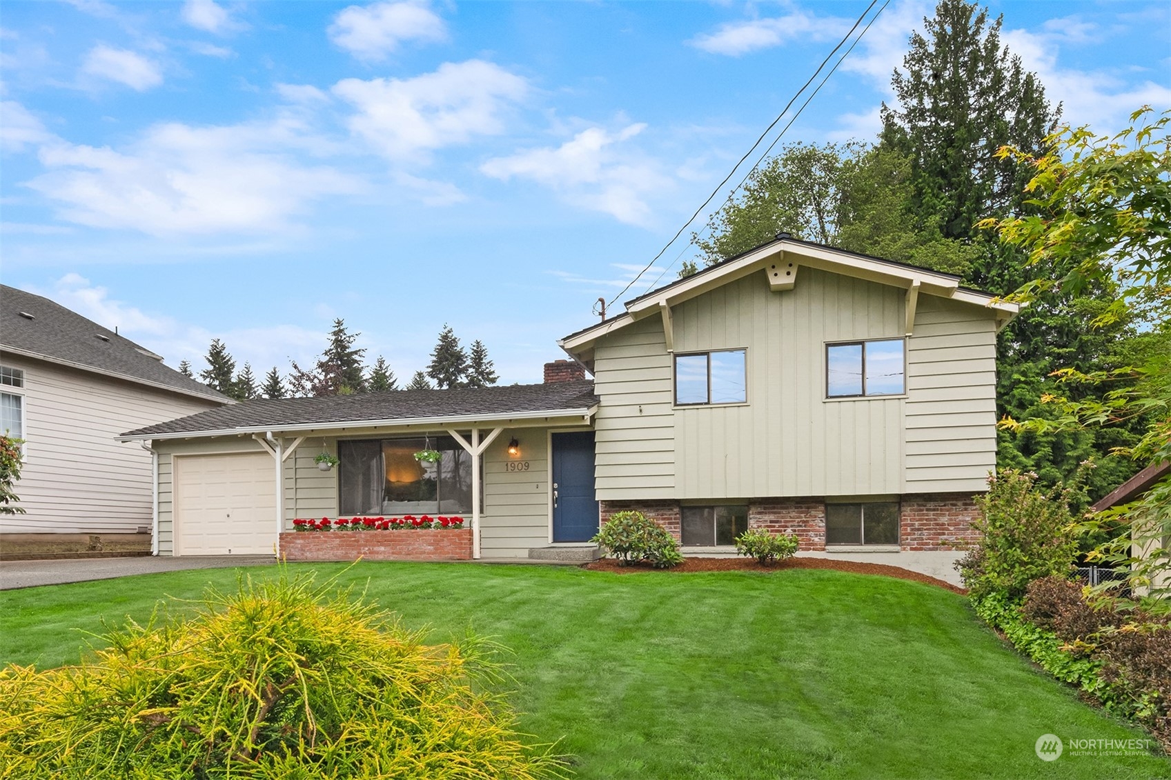 1909 Northeast 24th Street Renton, WA 98056 - Photo 34 of 34 a view of a house with backyard porch and garden