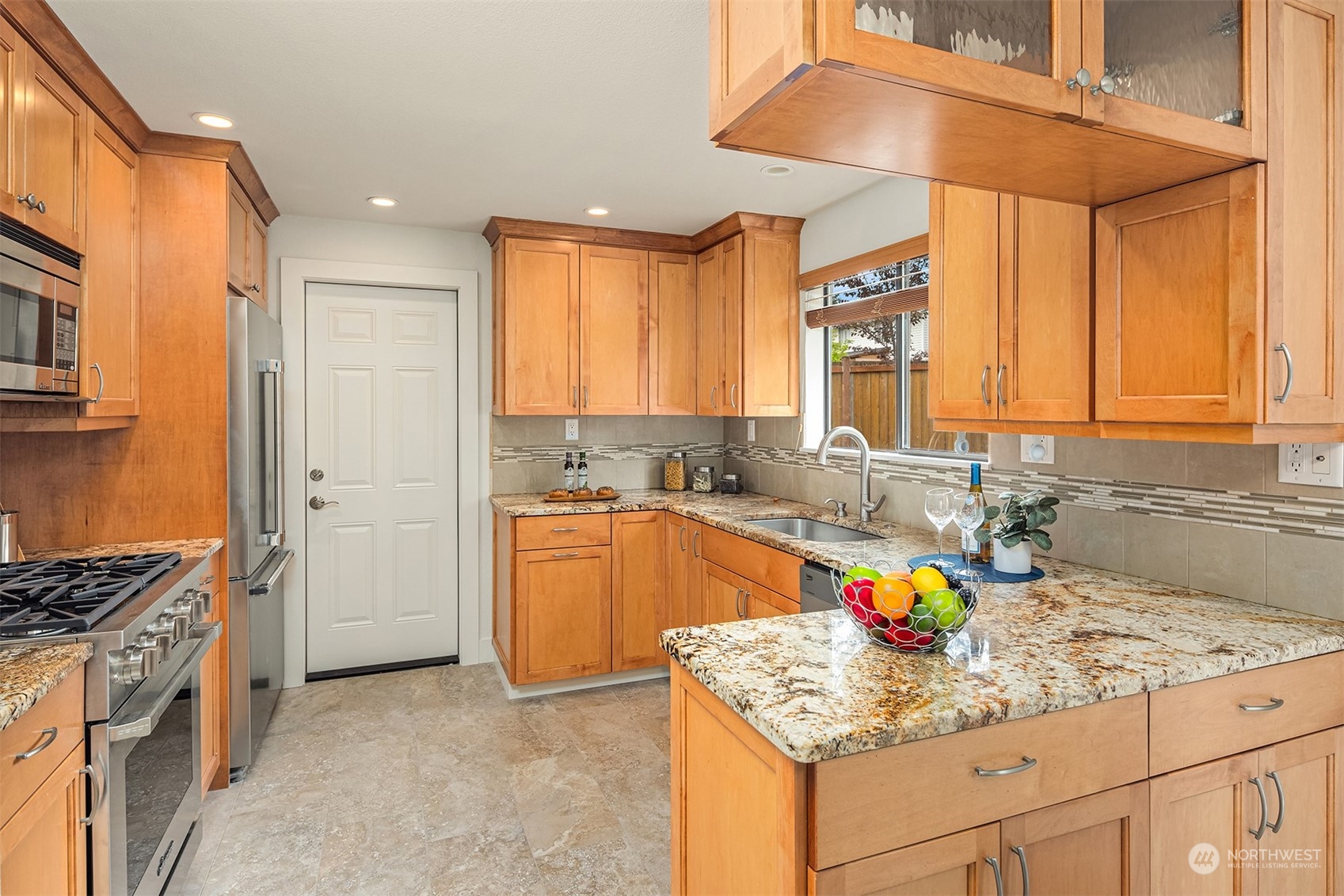 1909 Northeast 24th Street Renton, WA 98056 - Photo 6 of 34 a kitchen with stainless steel appliances granite countertop a sink stove and cabinets