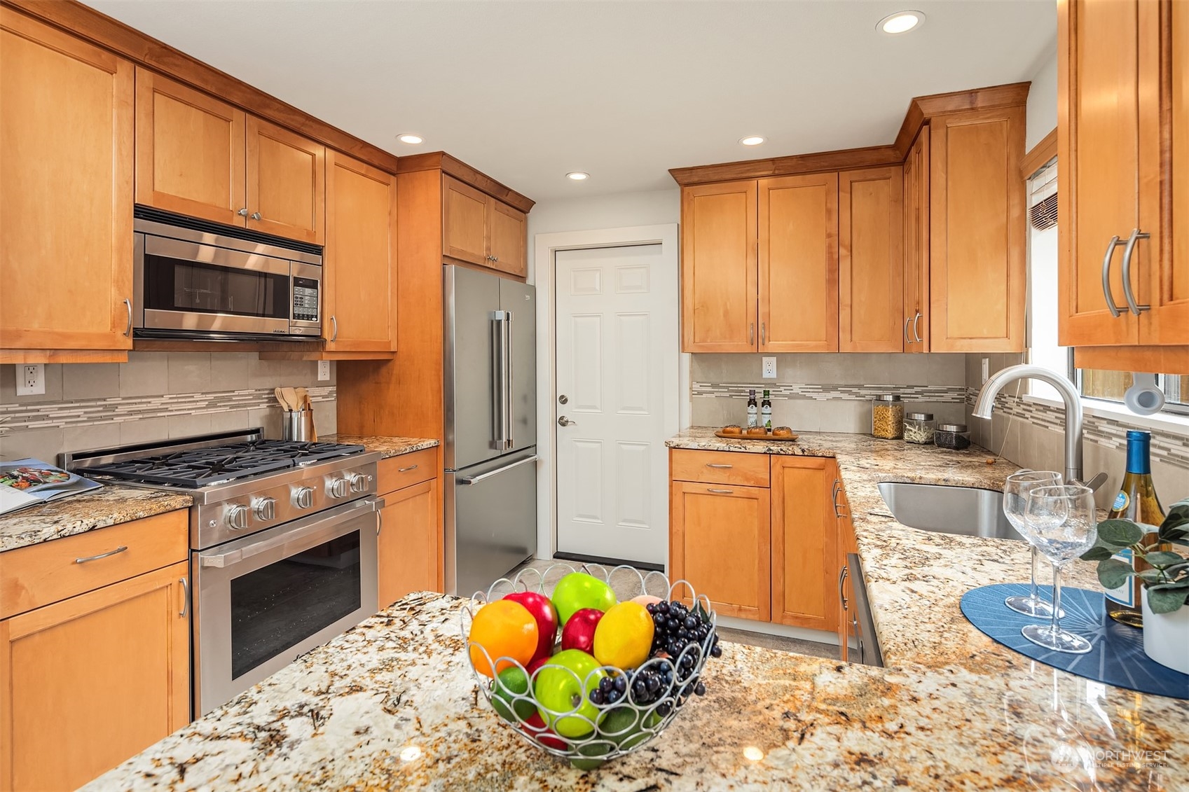 1909 Northeast 24th Street Renton, WA 98056 - Photo 7 of 34 a kitchen with stainless steel appliances granite countertop a stove refrigerator sink and a granite counter tops
