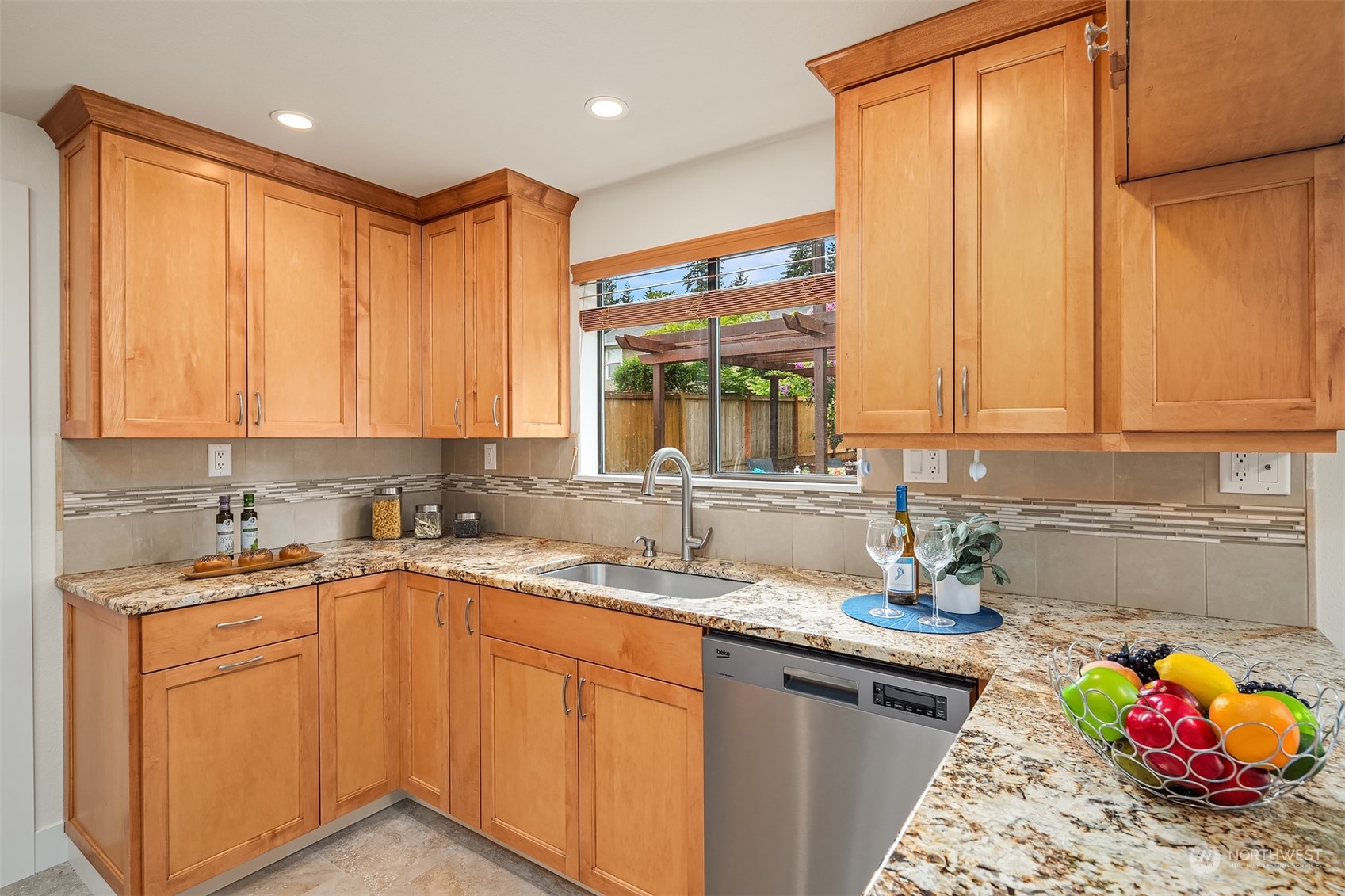 1909 Northeast 24th Street Renton, WA 98056 - Photo 8 of 34 a kitchen with stainless steel appliances granite countertop a sink stove and cabinets