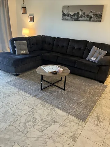 a lobby with furniture and a view of living room