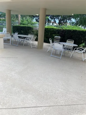 a view of a patio with chairs and plants