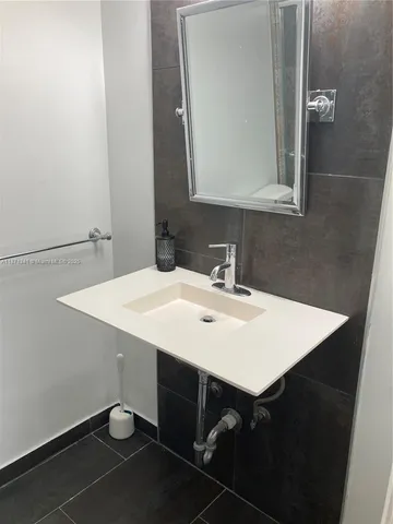 a bathroom with sink and mirror