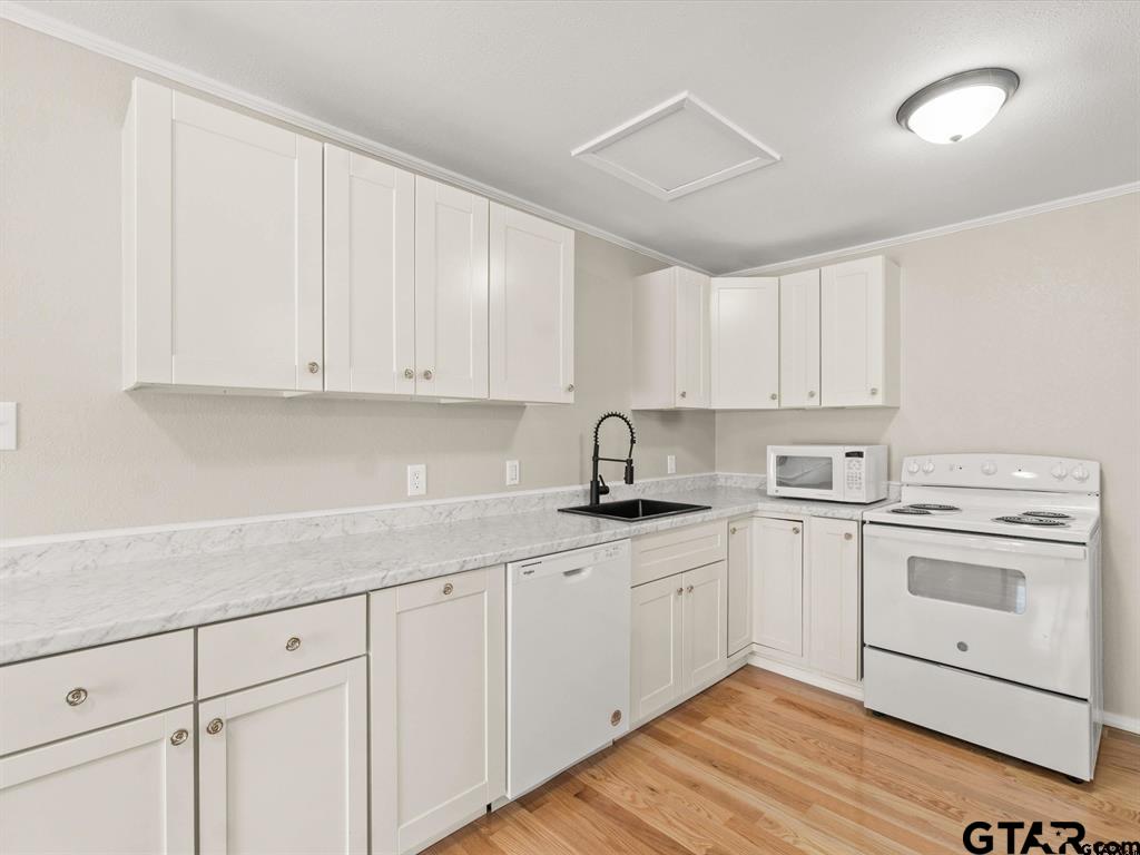 406 Giles Street Mineola, TX 75773 - Photo 13 of 19 a kitchen with white cabinets stainless steel appliances and sink