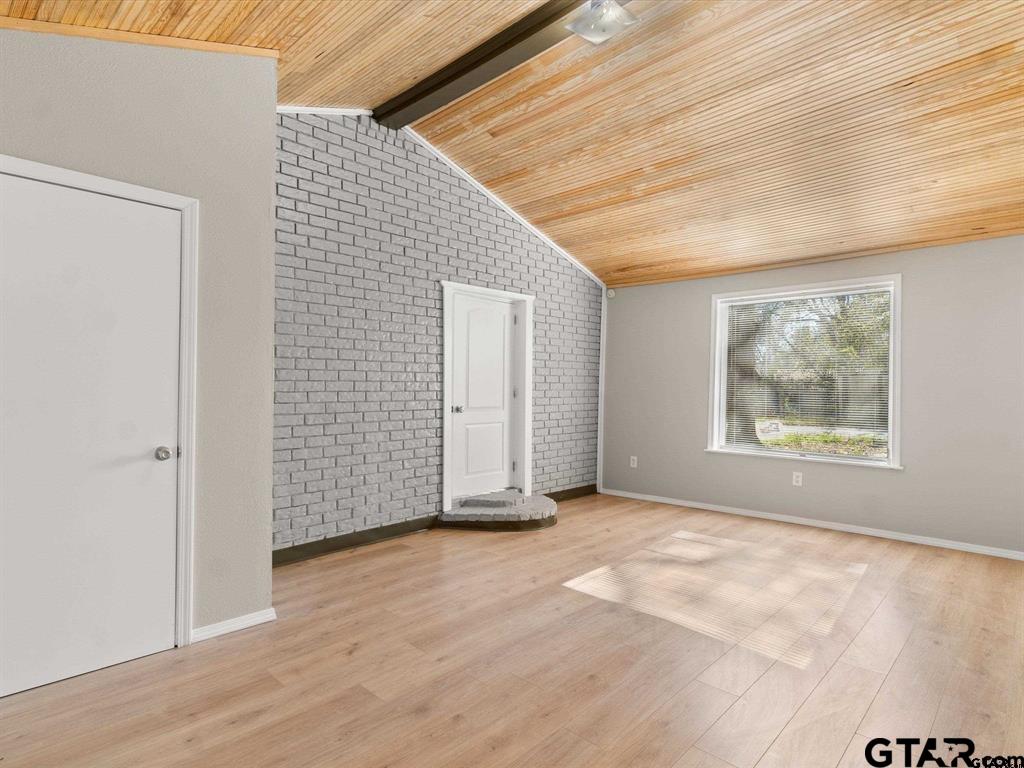 406 Giles Street Mineola, TX 75773 - Photo 14 of 19 an empty room with wooden floor and windows