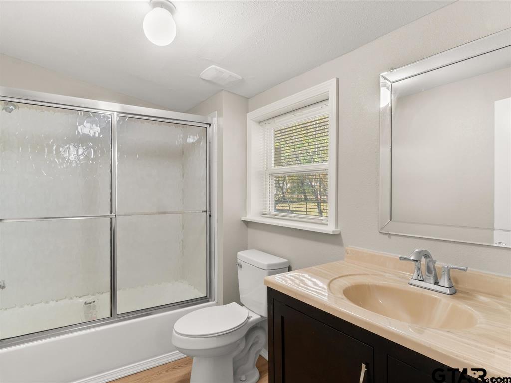 406 Giles Street Mineola, TX 75773 - Photo 17 of 19 a bathroom with a sink toilet and shower