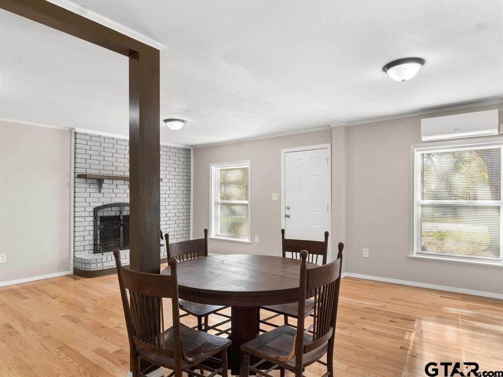 406 Giles Street Mineola, TX 75773 - Photo 5 of 19 a view of a dining room with furniture and wooden floor