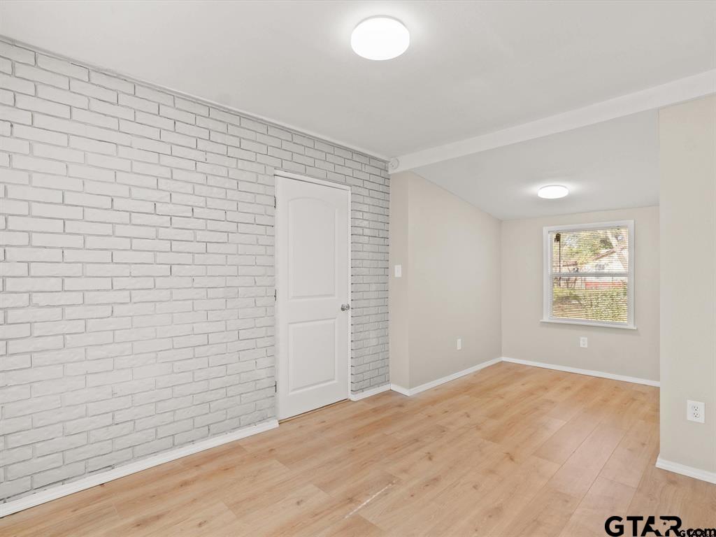 406 Giles Street Mineola, TX 75773 - Photo 7 of 19 an empty room with wooden floor and windows