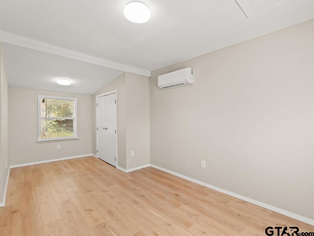 406 Giles Street Mineola, TX 75773 - Photo 8 of 19 a view of empty room with window and wooden floor