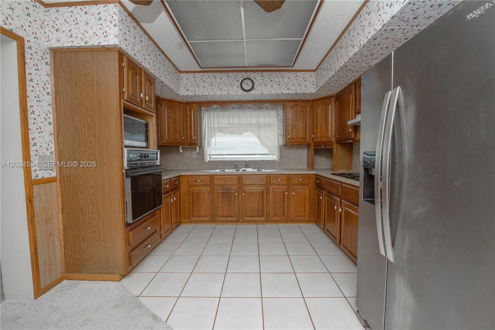 17355 Southwest 256th Street Homestead, FL 33031 - Photo 18 of 32 a kitchen with stainless steel appliances a refrigerator and a sink