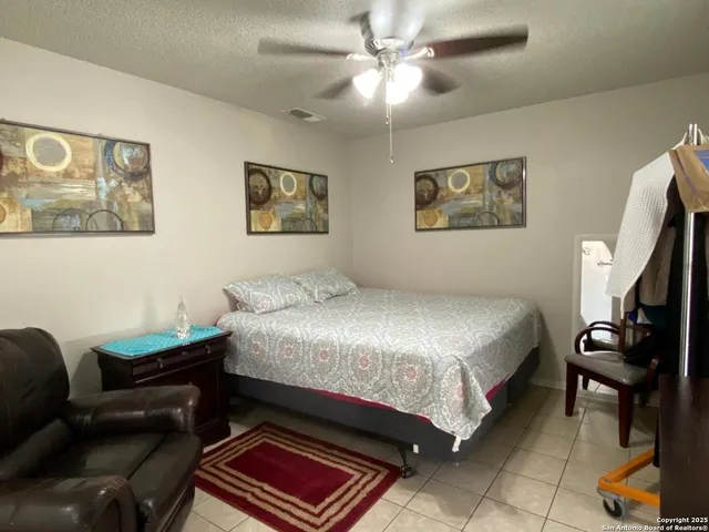 a bedroom with a bed and chair