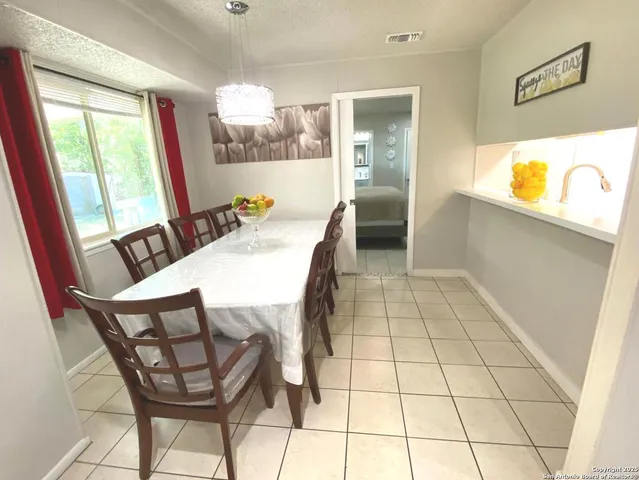 a view of a dining room with furniture and a floor to ceiling window