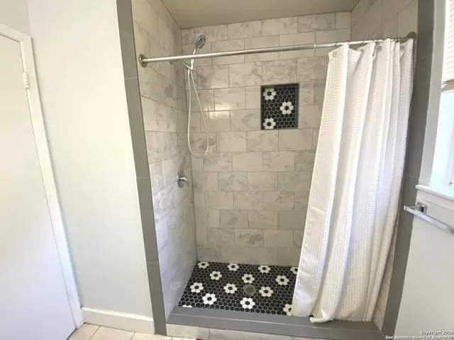 a bathroom with a shower and a sink