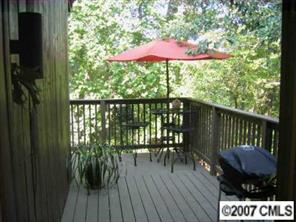4723 Rounding Run Road, Unit 4723 Charlotte, NC 28277 - Photo 5 of 8 a view of a balcony with wooden floor and outdoor seating