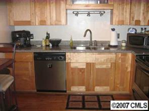 4723 Rounding Run Road, Unit 4723 Charlotte, NC 28277 - Photo 6 of 8 a kitchen with a sink and cabinets