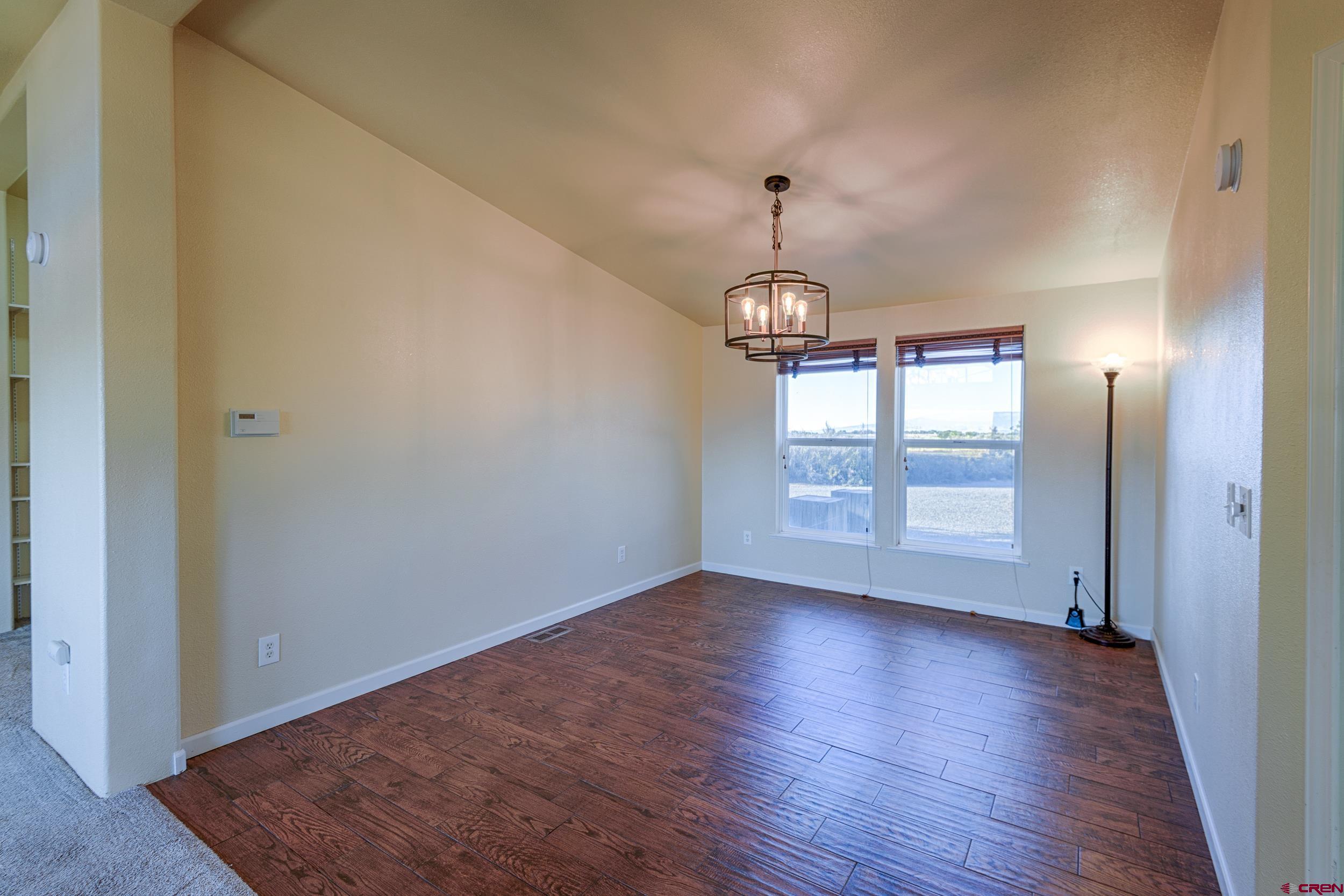 61928 Jay Jay Road Montrose, CO 81401 - Photo 11 of 36 an empty room with wooden floor and windows