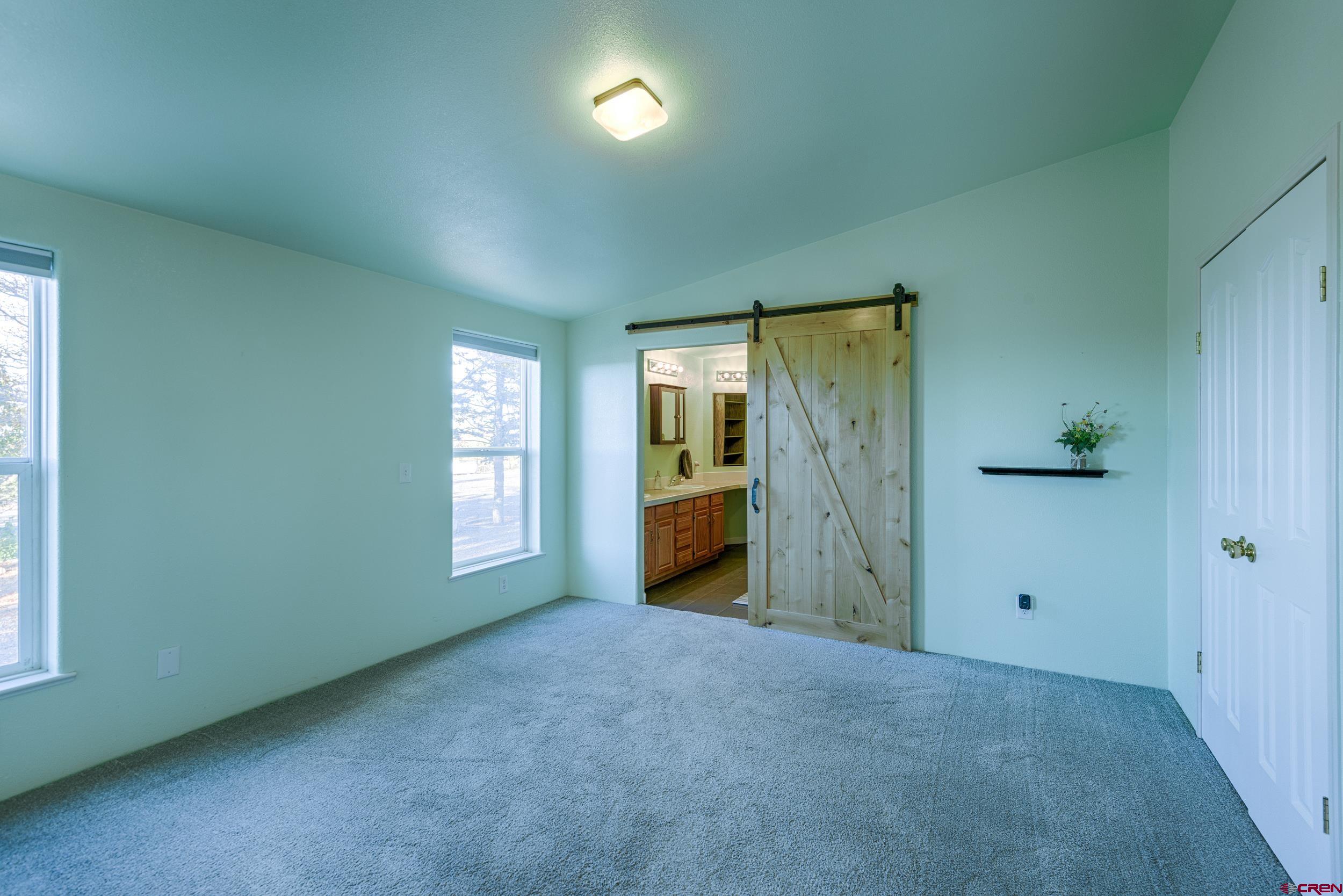 61928 Jay Jay Road Montrose, CO 81401 - Photo 13 of 36 an empty room with windows and closet