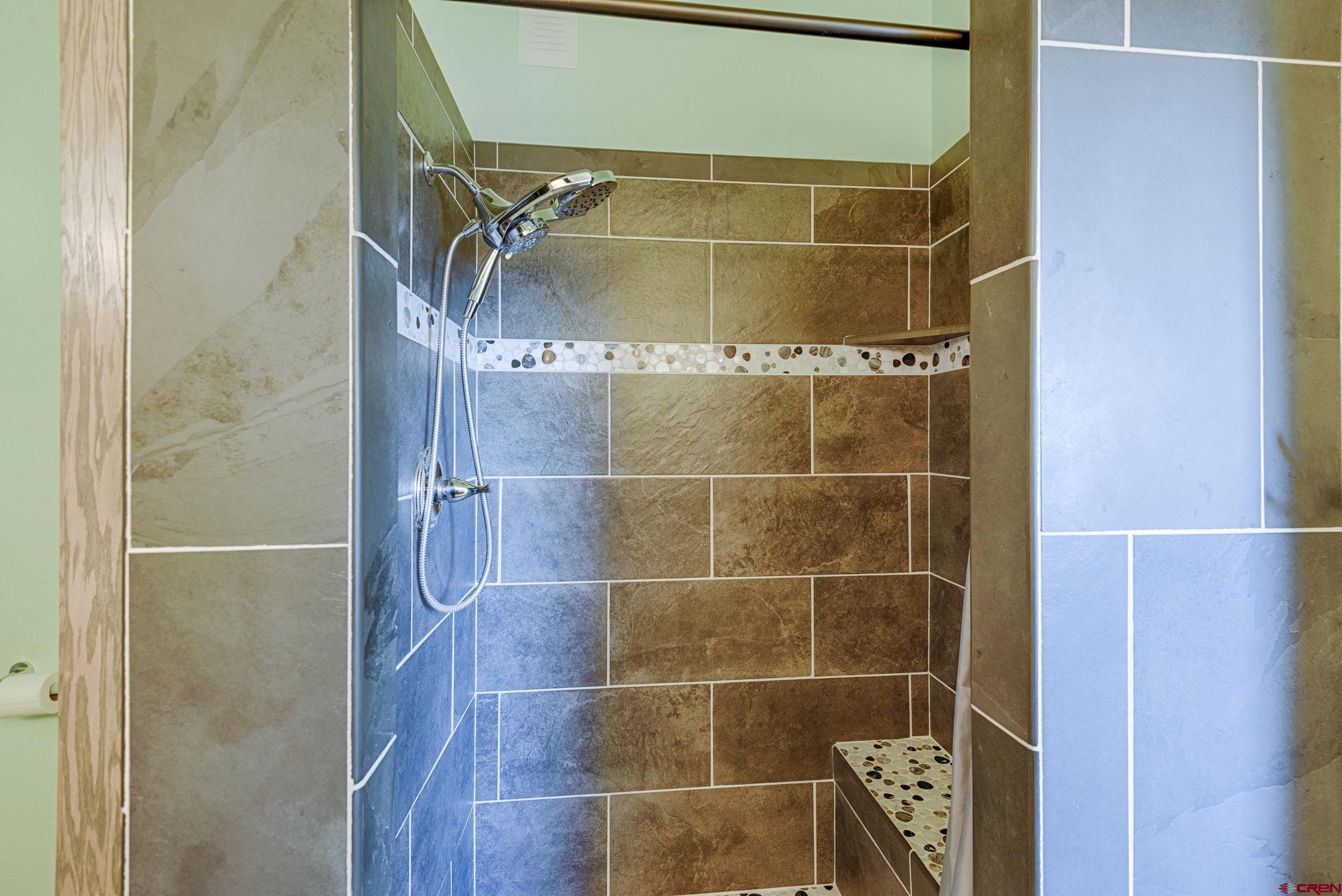 61928 Jay Jay Road Montrose, CO 81401 - Photo 15 of 36 a bathroom with a glass shower door