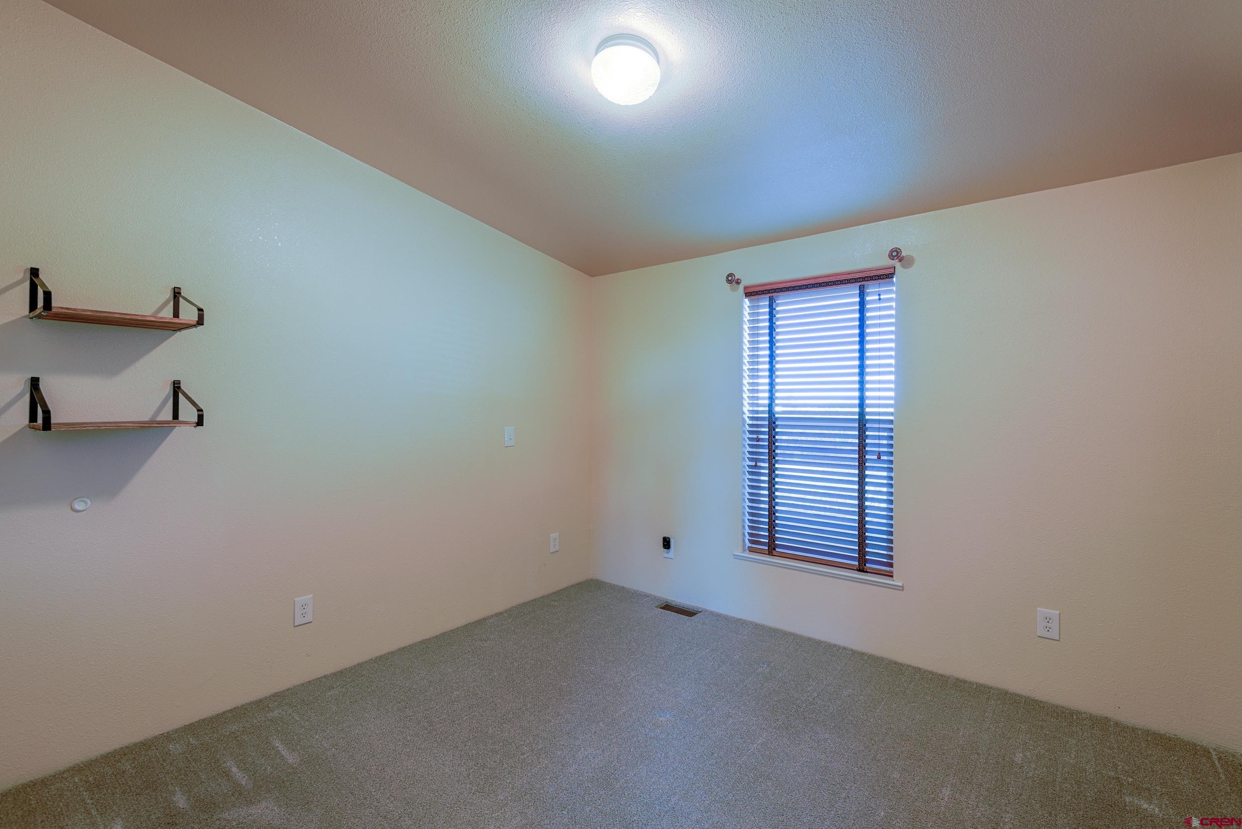 61928 Jay Jay Road Montrose, CO 81401 - Photo 16 of 36 an empty room with windows
