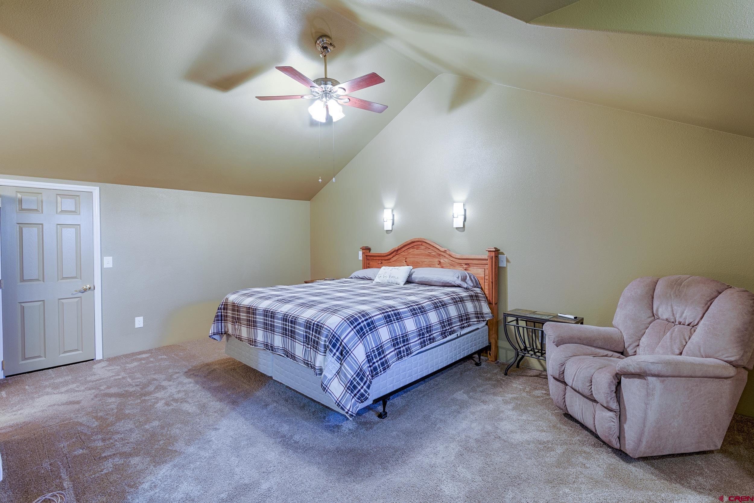 61928 Jay Jay Road Montrose, CO 81401 - Photo 20 of 36 a bedroom with a bed couch and painting on the wall