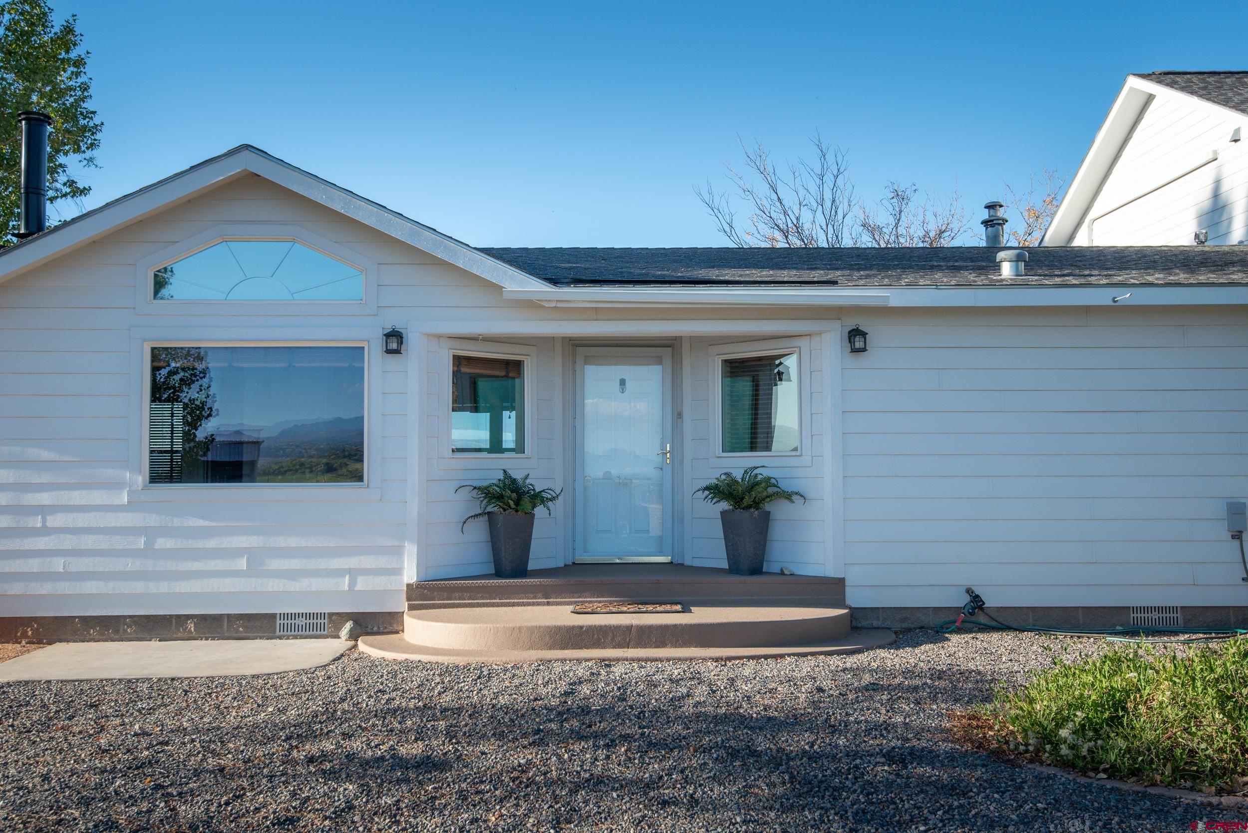 61928 Jay Jay Road Montrose, CO 81401 - Photo 2 of 36 a view of a house with a yard