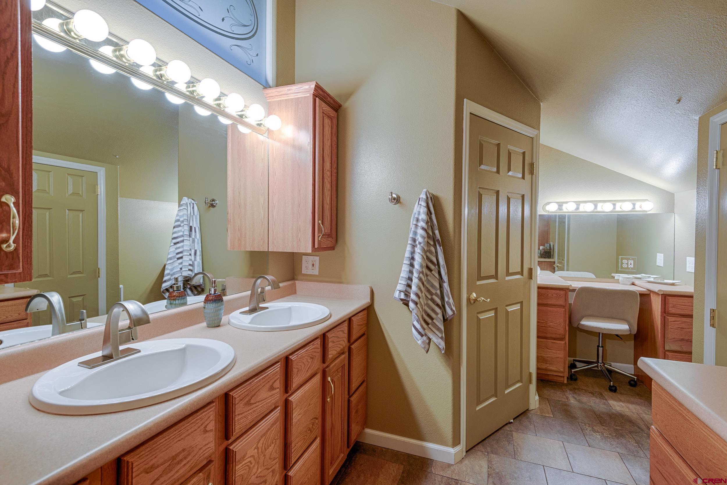 61928 Jay Jay Road Montrose, CO 81401 - Photo 23 of 36 a bathroom with double vanity and a mirror