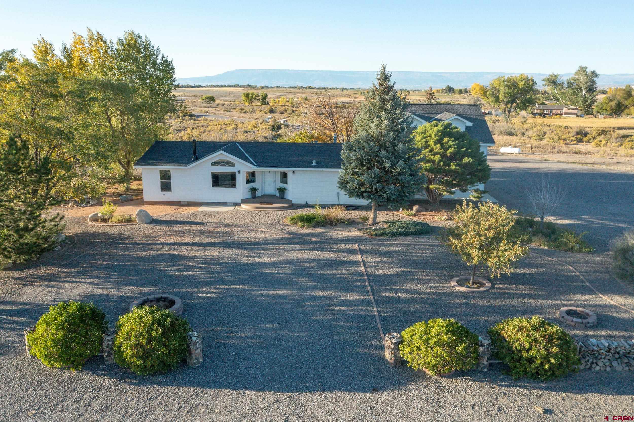 61928 Jay Jay Road Montrose, CO 81401 - Photo 26 of 36 a view of a house with a yard