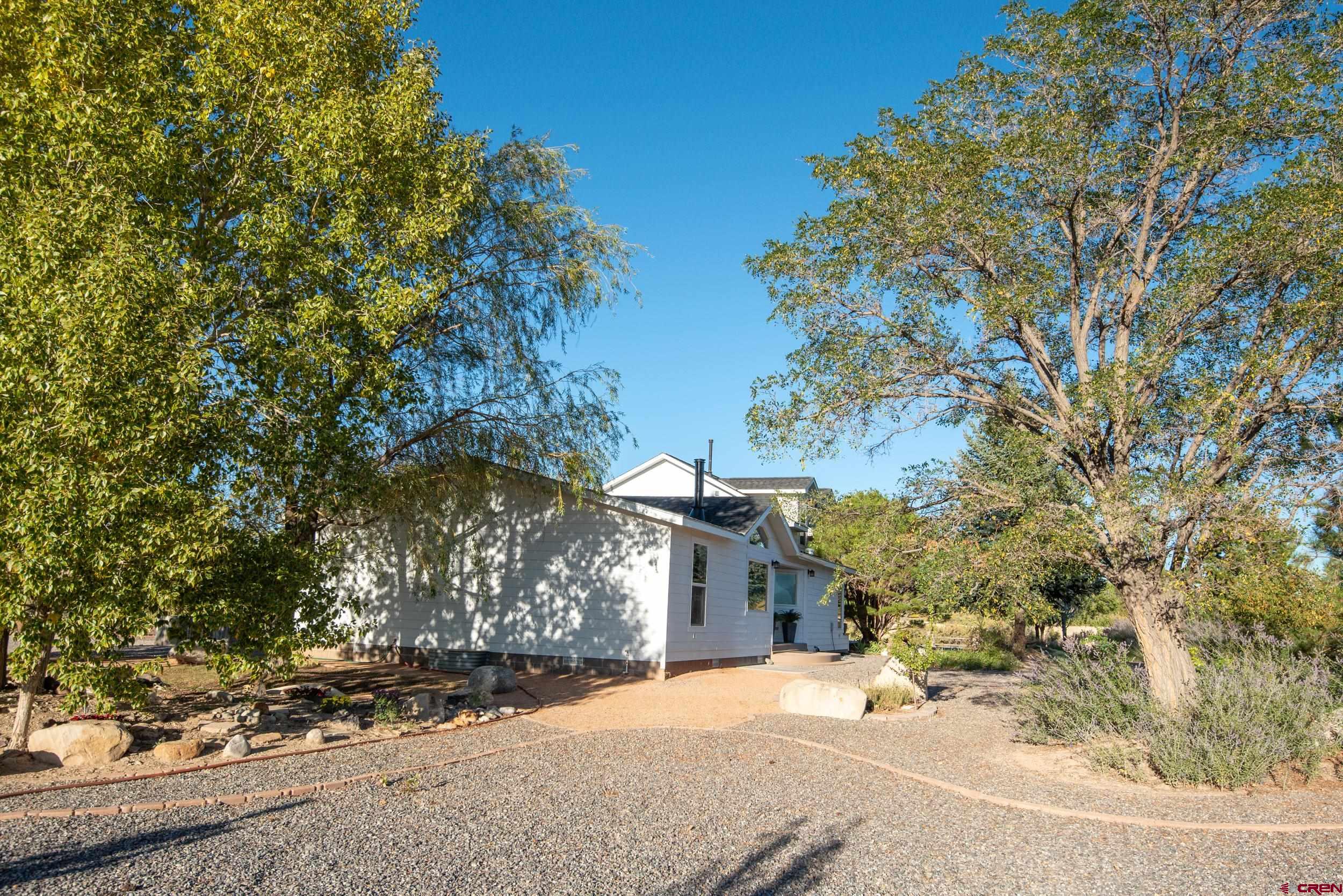 61928 Jay Jay Road Montrose, CO 81401 - Photo 27 of 36 a view of a house with a tree