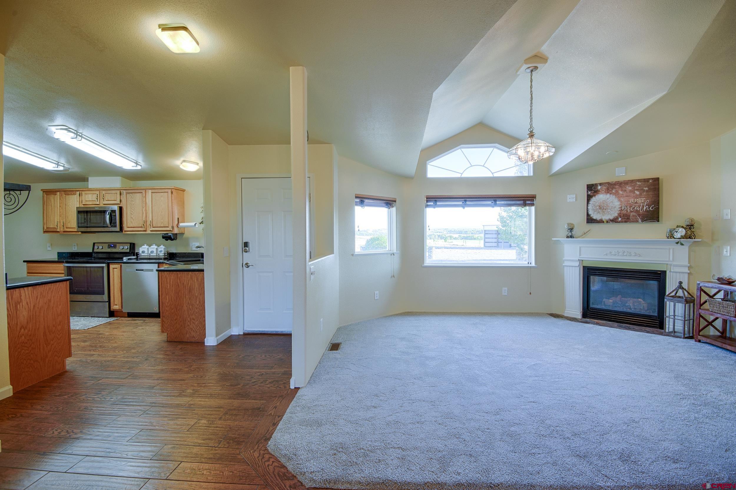 61928 Jay Jay Road Montrose, CO 81401 - Photo 3 of 36 a view of kitchen with furniture and a fireplace