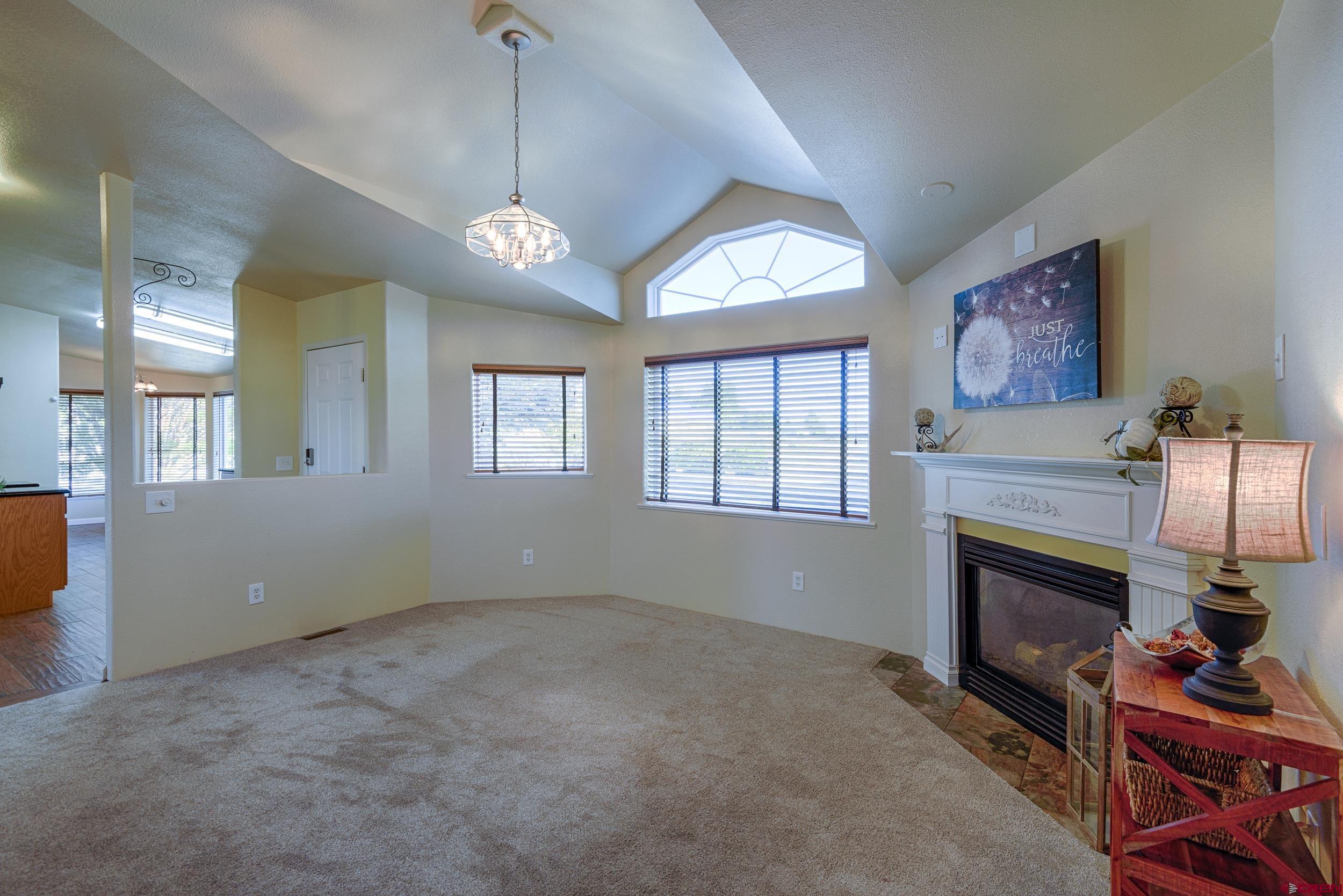 61928 Jay Jay Road Montrose, CO 81401 - Photo 4 of 36 a view of an empty room with a fireplace and a window