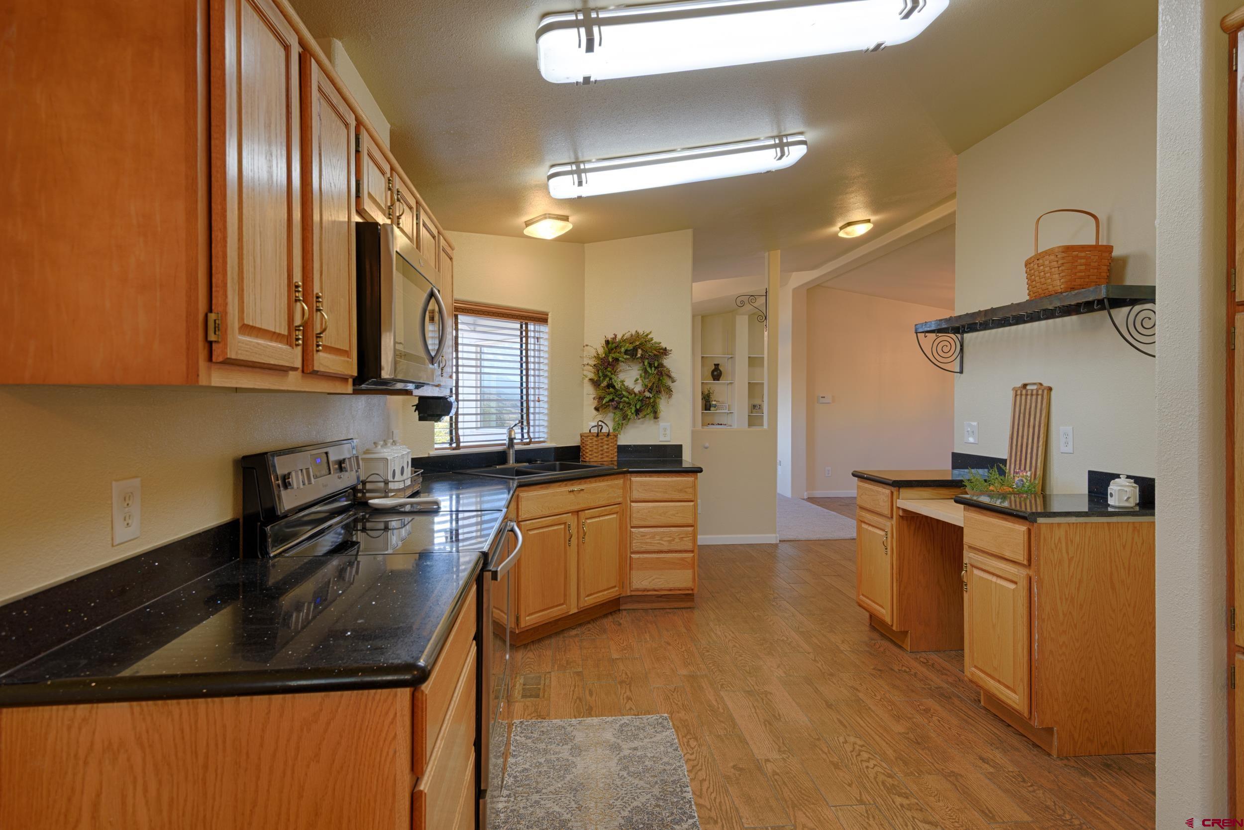 61928 Jay Jay Road Montrose, CO 81401 - Photo 10 of 36 a kitchen with stainless steel appliances granite countertop a sink stove and refrigerator