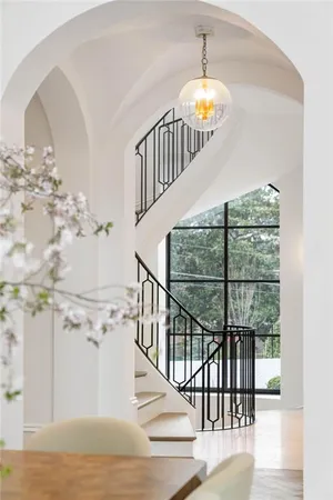 a living room with a large window and chandelier