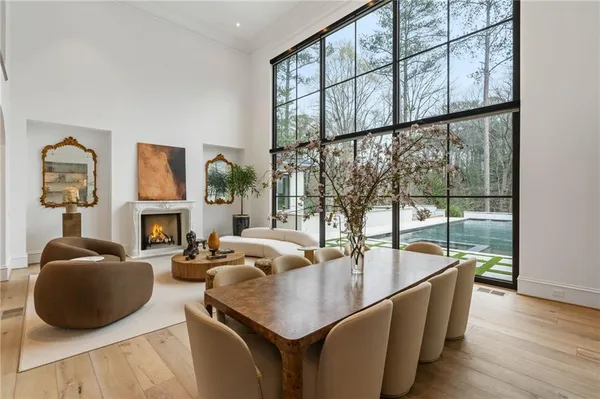 a living room with furniture and a floor to ceiling window